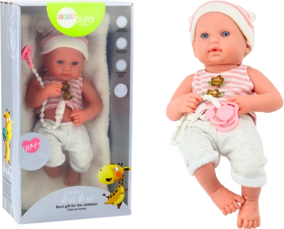 Babypuppe im weiß‑rosa Outfit mit Schnuller und Mützchen