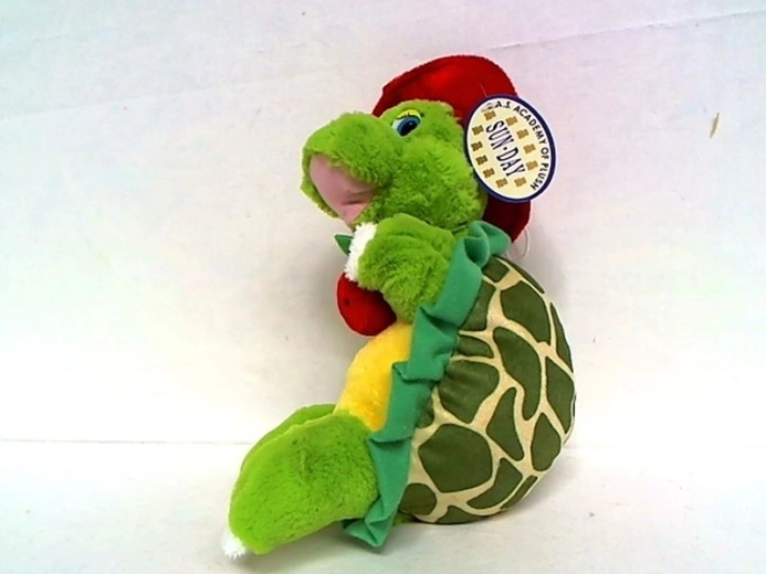 Plüschschildkröte mit rotem Hut und Apfel