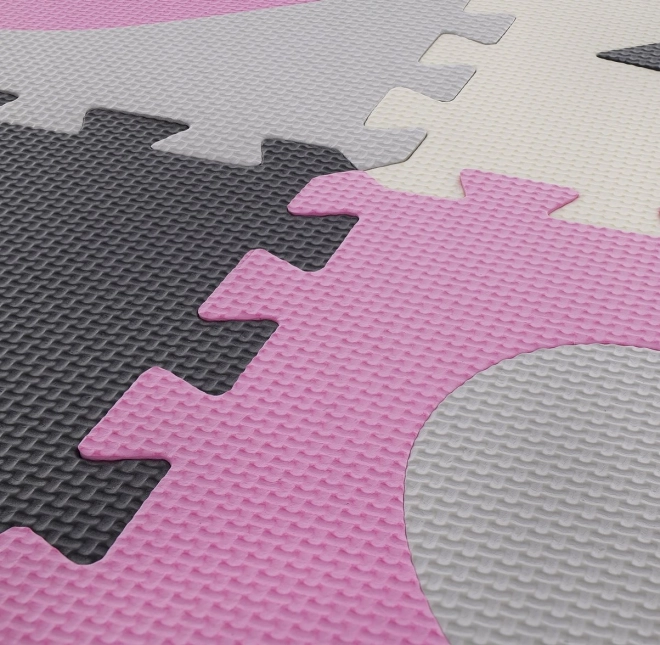 Puzzlematte mit Herz- und Sternmustern in Rosa und Grau