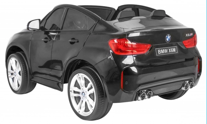 BMW X6M XXL pro 2 Kinder schwarz + Fernbedienung + Öko-Leder + Sicherheitsgurte + Langsame Anfahrt + MP3 USB + LED-Diode