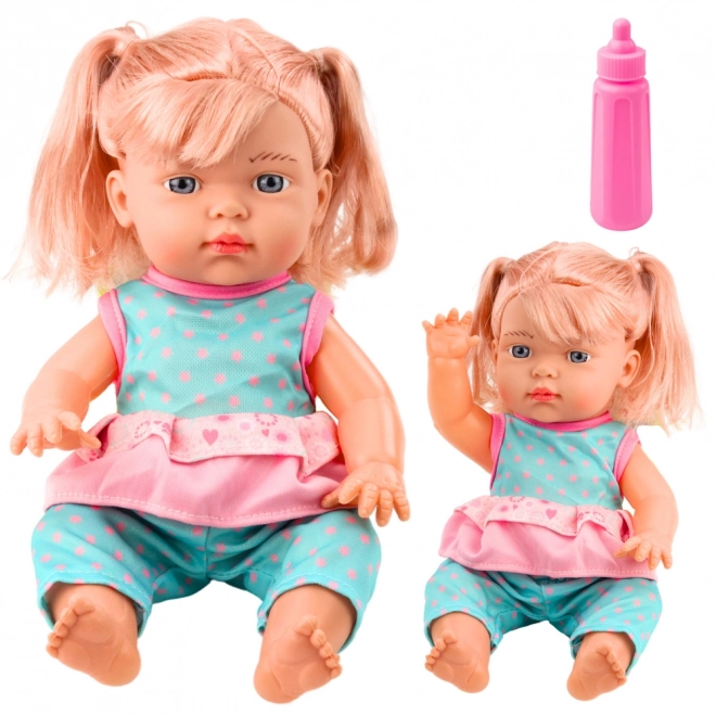 Puppe Baby in türkisfarbenem Set mit Flasche und Geräusch