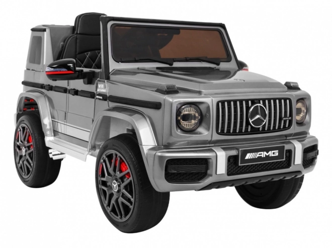 Mercedes AMG G63 für Kinder Silberlack + Fernbedienung + MP3 LED + langsamer Start + EVA + Gurte