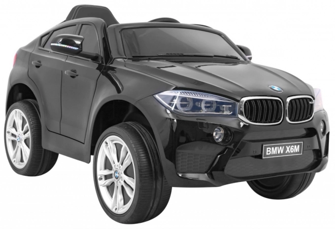 BMW X6M Elektrisches Kinderauto Schwarz + Fernbedienung + EVA + Langsamer Start + Audiopanel + LED-Diode
