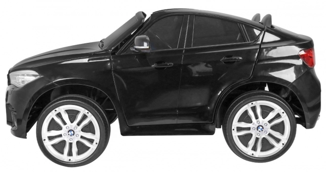 BMW X6M XXL pro 2 Kinder schwarz + Fernbedienung + Öko-Leder + Sicherheitsgurte + Langsame Anfahrt + MP3 USB + LED-Diode