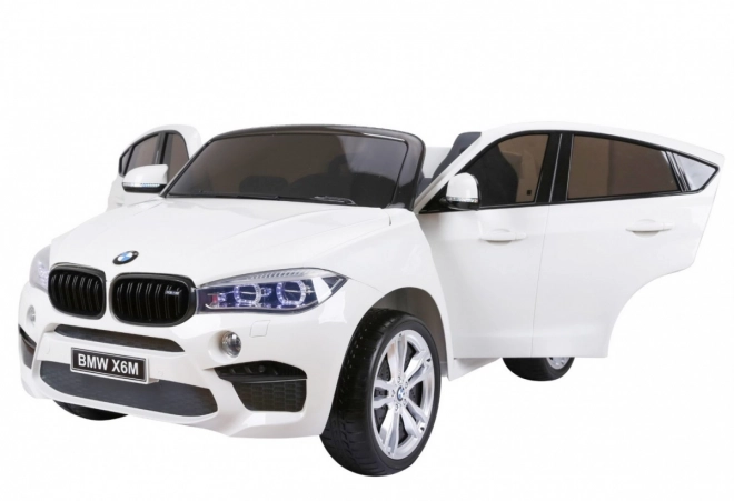 BMW X6M XXL pro 2 Kinder Weiß + Fernsteuerung + Eco-Leder + Sicherheitsgurte + langsamer Start + MP3 USB + LED