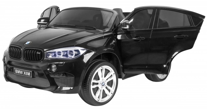 BMW X6M XXL pro 2 Kinder schwarz + Fernbedienung + Öko-Leder + Sicherheitsgurte + Langsame Anfahrt + MP3 USB + LED-Diode