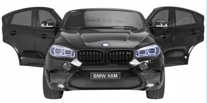 BMW X6M XXL pro 2 Kinder schwarz + Fernbedienung + Öko-Leder + Sicherheitsgurte + Langsame Anfahrt + MP3 USB + LED-Diode