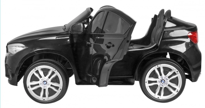 BMW X6M XXL pro 2 Kinder schwarz + Fernbedienung + Öko-Leder + Sicherheitsgurte + Langsame Anfahrt + MP3 USB + LED-Diode