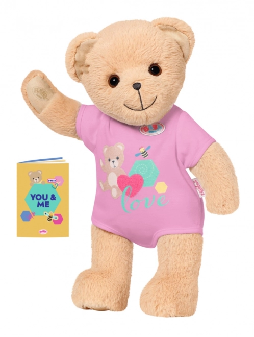 Babypuppe mit süßem Teddybär in rosa Outfit