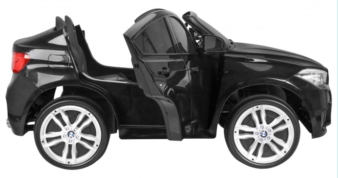 BMW X6M XXL pro 2 Kinder schwarz + Fernbedienung + Öko-Leder + Sicherheitsgurte + Langsame Anfahrt + MP3 USB + LED-Diode