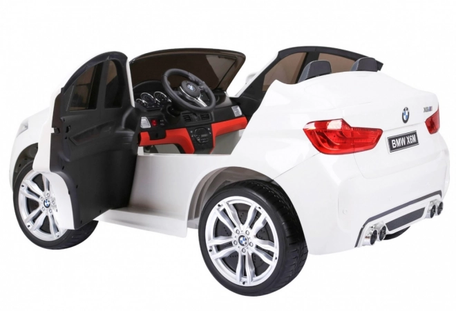 BMW X6M XXL pro 2 Kinder Weiß + Fernsteuerung + Eco-Leder + Sicherheitsgurte + langsamer Start + MP3 USB + LED