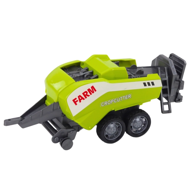 Grüner Traktor mit Lader und kompatibler Ballenpresse