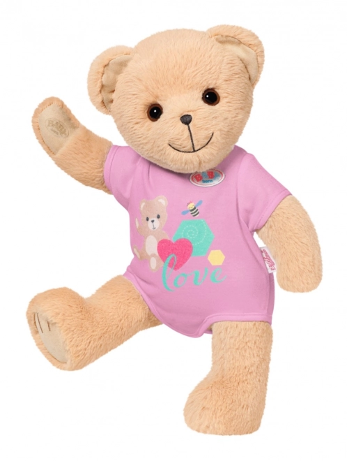 Babypuppe mit süßem Teddybär in rosa Outfit