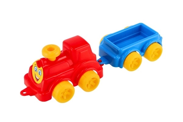 Bunte Kinderspielzeug-Lokomotive mit Waggon