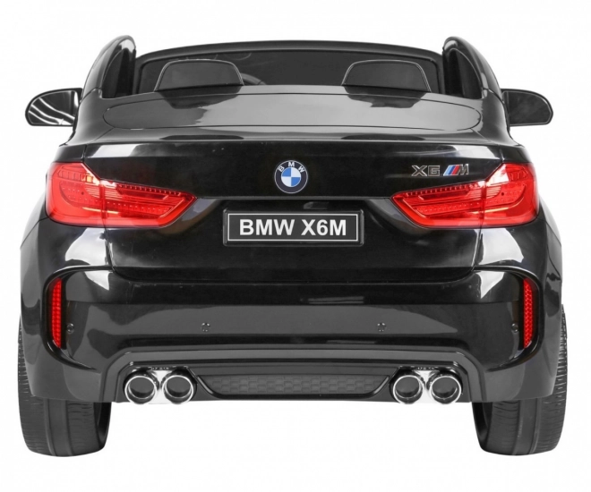 BMW X6M XXL pro 2 Kinder schwarz + Fernbedienung + Öko-Leder + Sicherheitsgurte + Langsame Anfahrt + MP3 USB + LED-Diode
