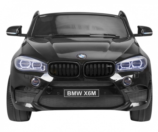 BMW X6M XXL pro 2 Kinder schwarz + Fernbedienung + Öko-Leder + Sicherheitsgurte + Langsame Anfahrt + MP3 USB + LED-Diode