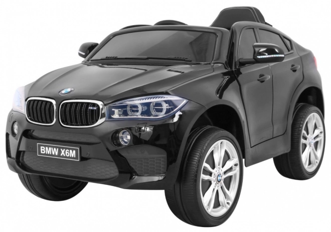 BMW X6M Elektrisches Kinderauto Schwarz + Fernbedienung + EVA + Langsamer Start + Audiopanel + LED-Diode