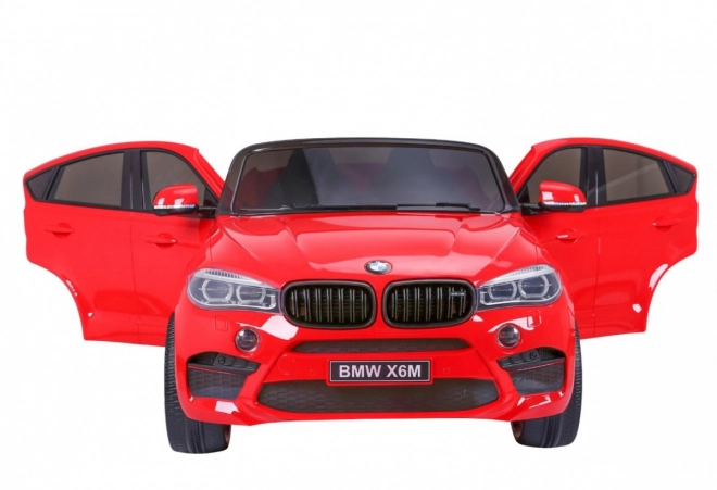 BMW X6M XXL pro 2 Kinder Rot + Fernbedienung + Ökoleder + Sicherheitsgurte + Langsamer Start + MP3 USB + LED-Leuchte