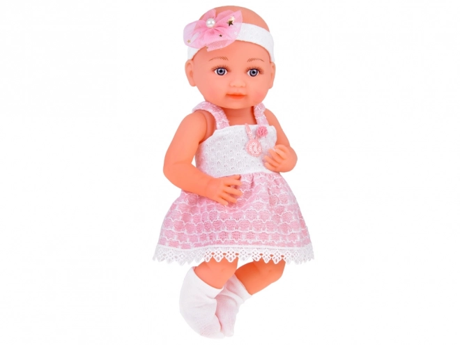 Gummipuppe Baby mit rosa Kleid