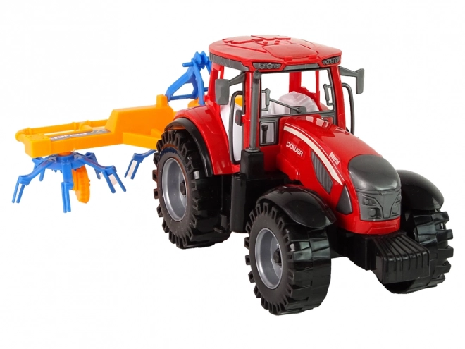 Roter Traktor mit Schwader Friktionsantrieb