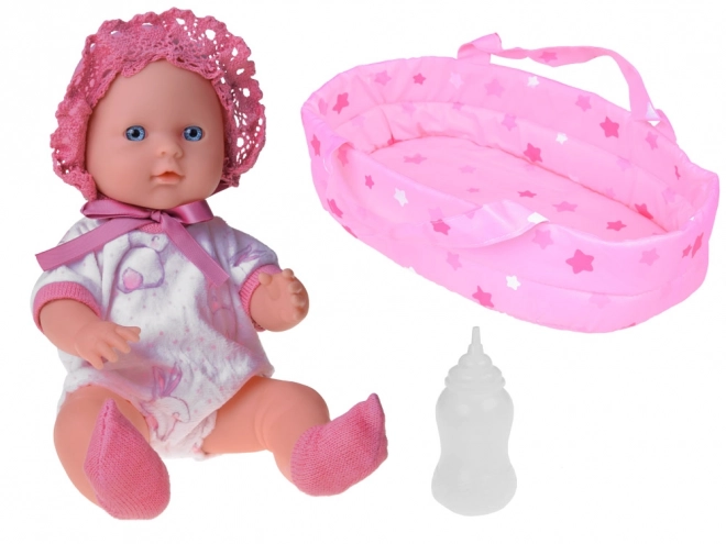 Babypuppe mit Träger und Flasche