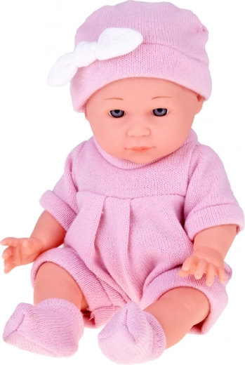 Realistisches Baby im rosafarbenen Strickoutfit