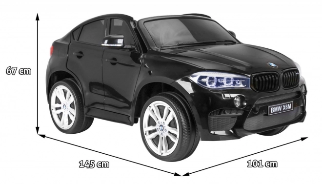 BMW X6M XXL pro 2 Kinder schwarz + Fernbedienung + Öko-Leder + Sicherheitsgurte + Langsame Anfahrt + MP3 USB + LED-Diode