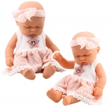 Schlafende Babypuppe in rosa Kleid mit Spitze und Sternstirnband