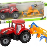Roter Traktor mit Schwader und Reibungsantrieb
